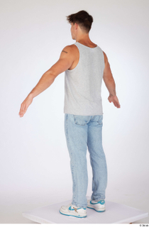 Darren a-poses blue jeans casual dressed grey tank top standing…